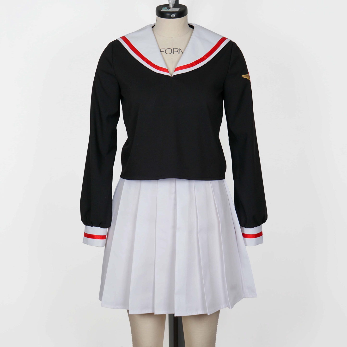 Full view of a black, long-sleeved Japanese school uniform (seifuku) with a white sailor collar trimmed in red, paired with a white pleated skirt, displayed on a mannequin.