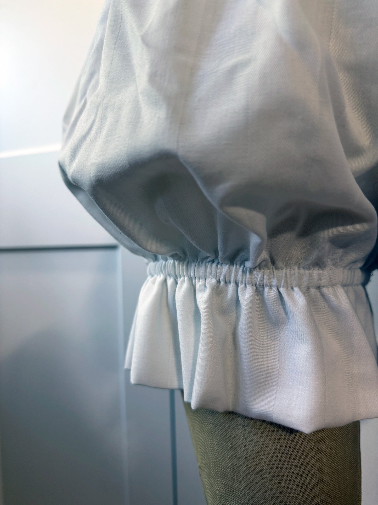 a close up of ruffled shorts being displayed on a mannequin showing the elastic at the hem and the topstitches in detail