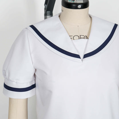 Cropped shot showcasing the details of a white seifuku top with a navy blue trimmed sailor collar and short sleeves with matching navy blue trim. The top is displayed on a mannequin.