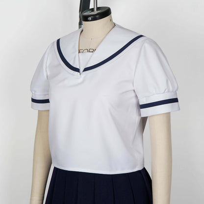 Upper body shot of a mannequin wearing a white seifuku top with a navy blue sailor collar and matching trim on the short sleeves. A dark navy blue skirt is visible beneath the top. The background is a plain white studio backdrop.